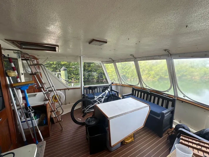  Yacht Photos Pics Interior of 1980 Hatteras 53 Motoryacht with seating, table, and bicycle.
