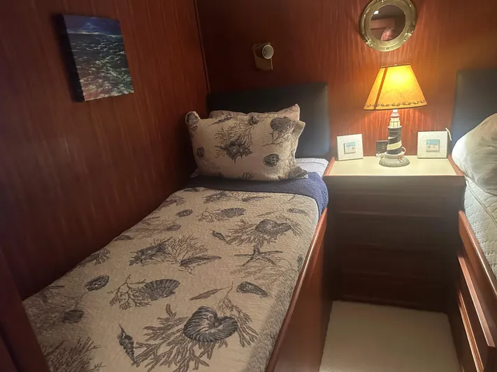  Yacht Photos Pics Cozy cabin interior of 1980 Hatteras 53 Motoryacht with nautical-themed bedding and decor.