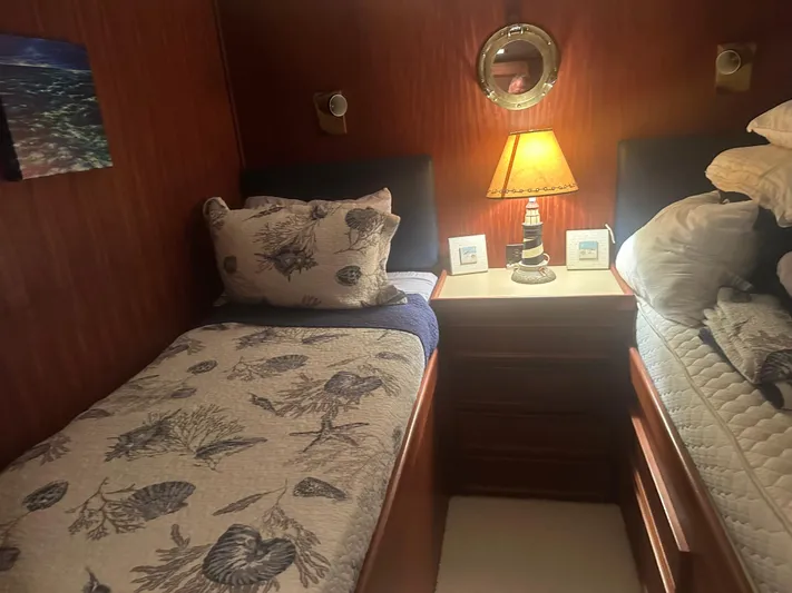  Yacht Photos Pics Cozy cabin interior of 1980 Hatteras 53 Motoryacht with twin beds and nautical decor.