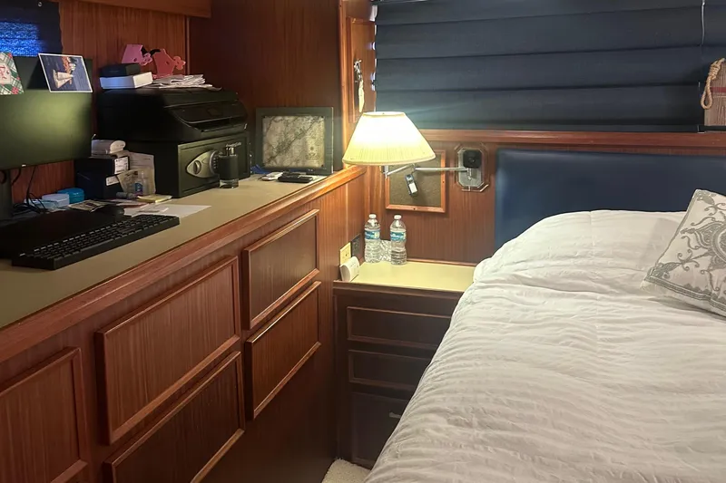  Yacht Photos Pics Cozy cabin interior of 1980 Hatteras 53 Motoryacht with bed, desk, and lamp.
