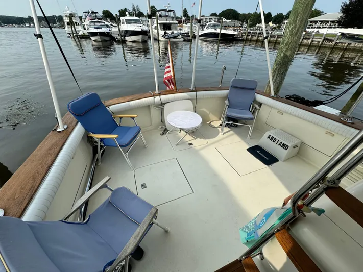  Yacht Photos Pics 1993 Ocean Yachts 42 Super Sport deck with chairs and table, docked at marina.