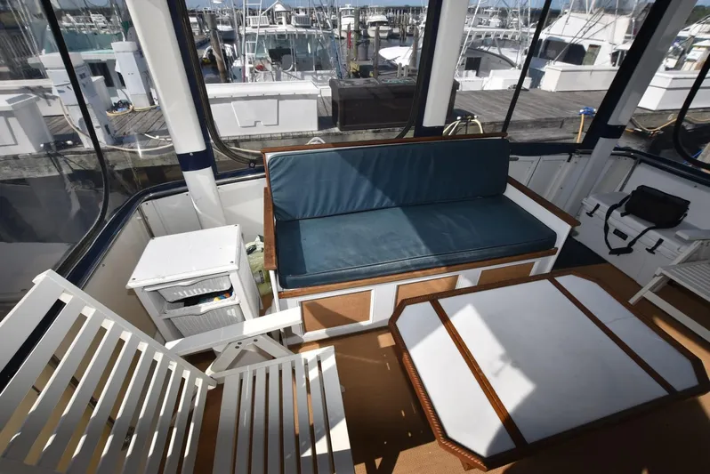 Miss Dot Yacht Photos Pics 1997 Carver 405 Aft Cabin Motoryacht interior with seating and table, docked at marina.