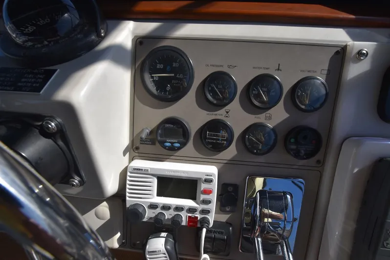Miss Dot Yacht Photos Pics Control panel of a 1997 Carver 405 Aft Cabin Motoryacht with gauges and radio equipment.