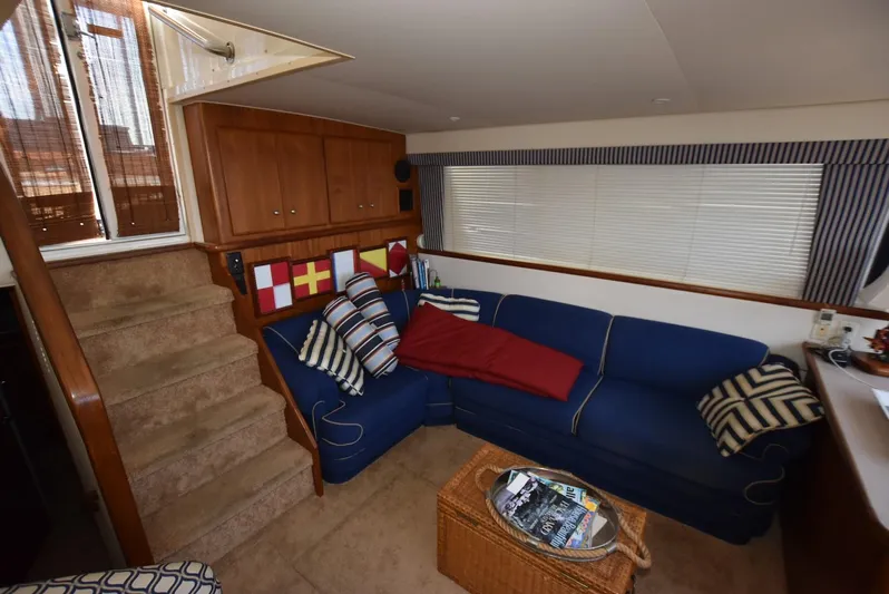 Miss Dot Yacht Photos Pics Interior of 1997 Carver 405 Aft Cabin Motoryacht with blue sofa and nautical decor.
