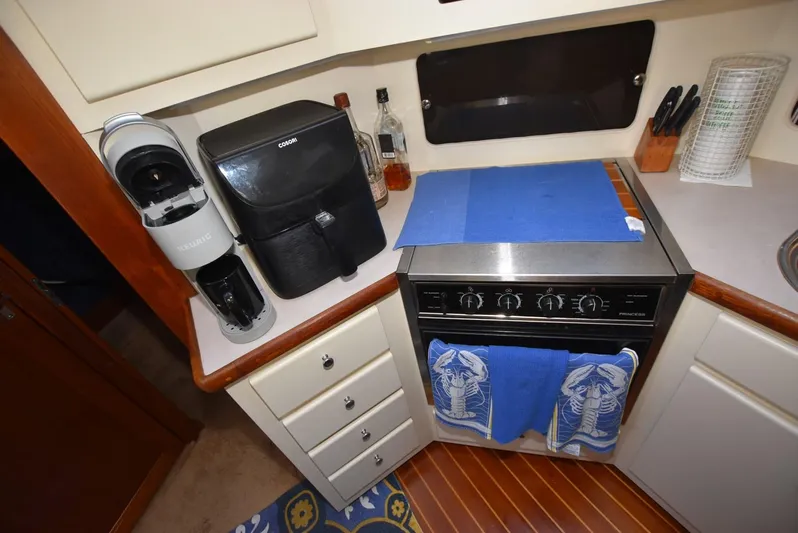 Miss Dot Yacht Photos Pics 1997 Carver 405 Aft Cabin Motoryacht kitchen with stove, coffee maker, and storage.