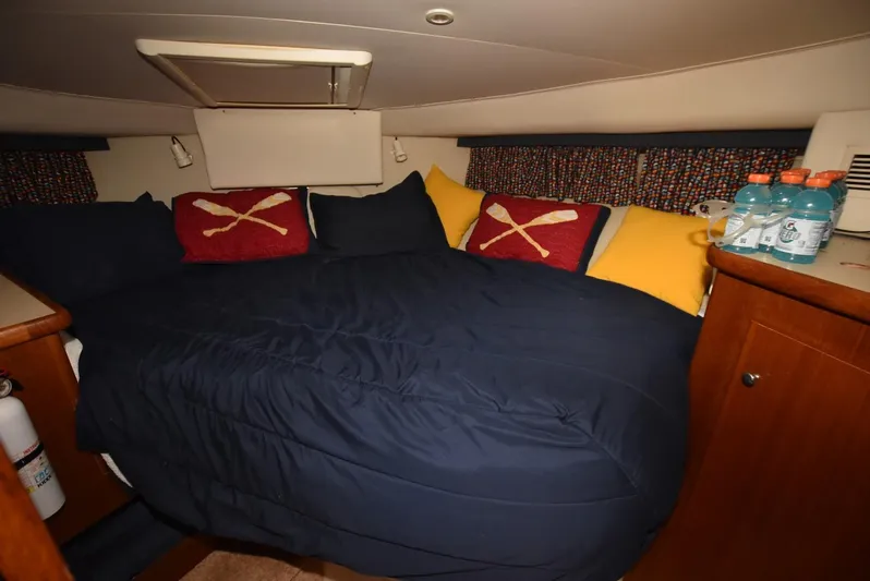 Miss Dot Yacht Photos Pics 1997 Carver 405 Aft Cabin Motoryacht bedroom with cozy bedding and nautical-themed pillows.