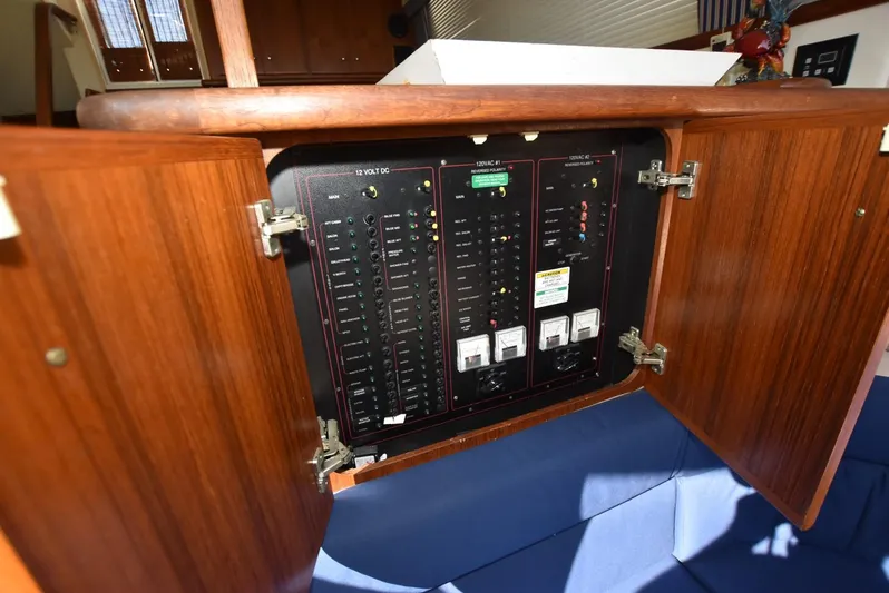 Miss Dot Yacht Photos Pics Electrical panel inside 1997 Carver 405 Aft Cabin Motoryacht, wooden cabinet open.