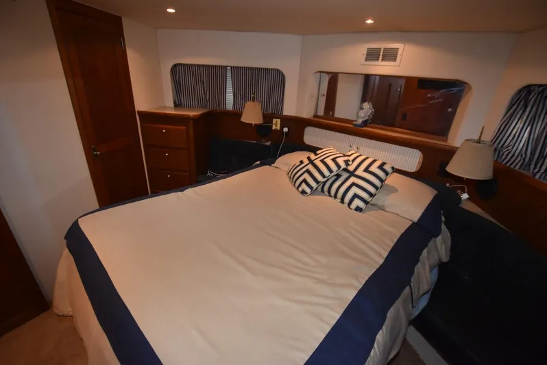 Miss Dot Yacht Photos Pics 1997 Carver 405 Aft Cabin Motoryacht bedroom with cozy bed and nautical decor.