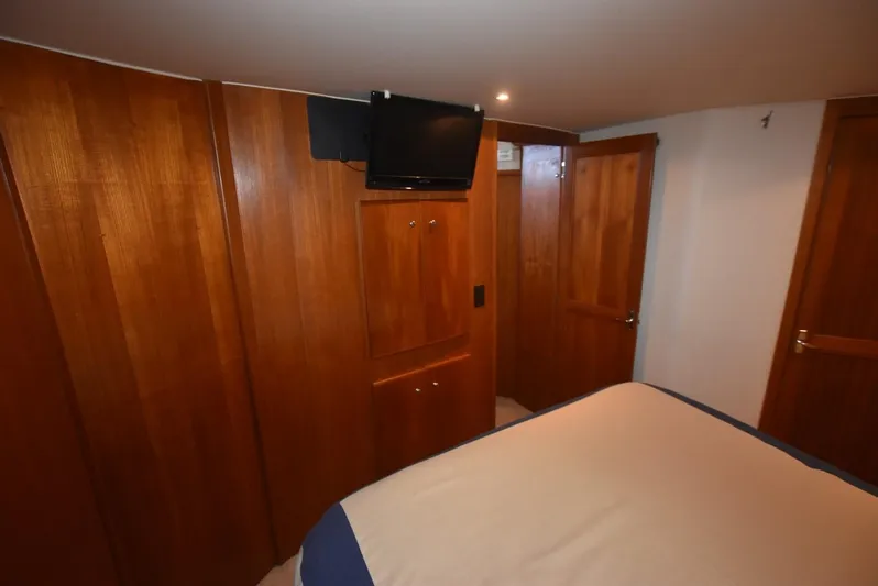 Miss Dot Yacht Photos Pics 1997 Carver 405 Aft Cabin Motoryacht interior with wood paneling and mounted TV.