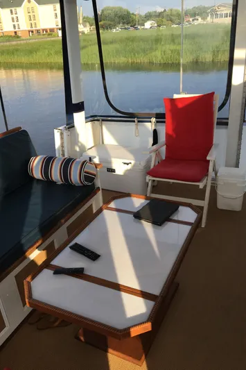 Miss Dot Yacht Photos Pics 1997 Carver 405 Aft Cabin Motoryacht interior with seating, table, and water view.