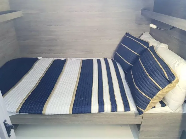 Calypso Yacht Photos Pics Cozy cabin bed with striped bedding in 2021 Fountaine Pajot MY6 yacht.