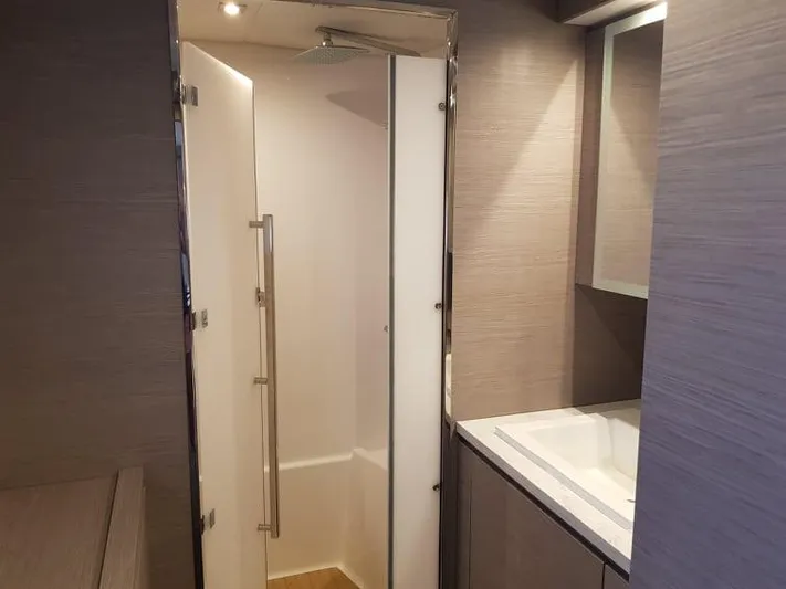 Calypso Yacht Photos Pics Modern bathroom interior on 2021 Fountaine Pajot MY6 yacht, featuring sleek shower and vanity.