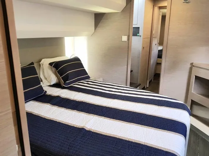 Calypso Yacht Photos Pics Bedroom interior of 2021 Fountaine Pajot MY6 yacht with striped bedding.