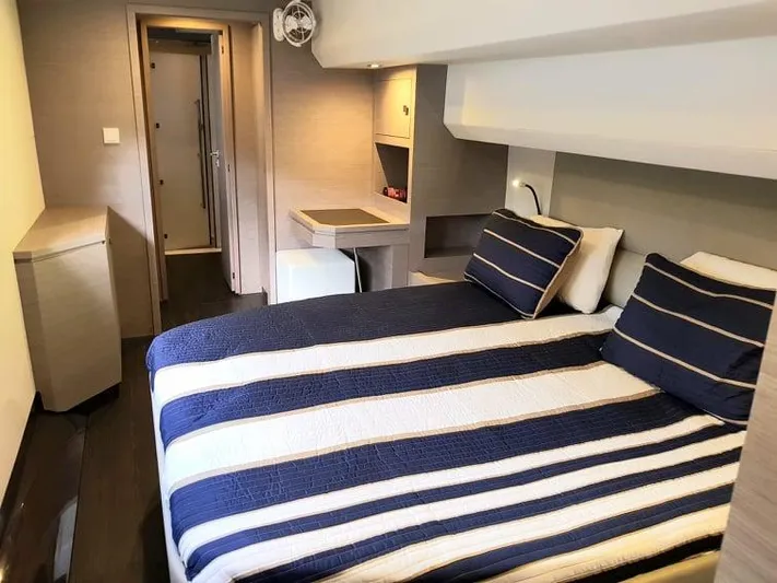 Calypso Yacht Photos Pics 2021 Fountaine Pajot MY6 cabin with striped bedding and modern interior design.