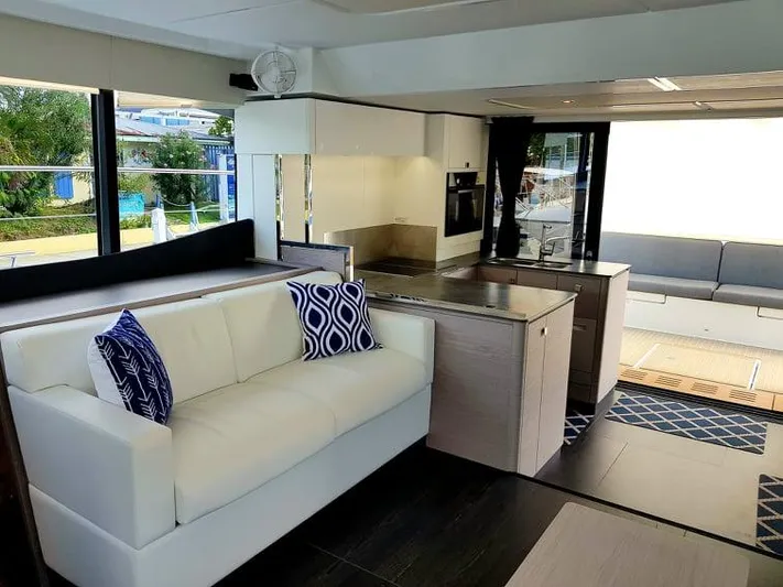 Calypso Yacht Photos Pics Luxurious interior of 2021 Fountaine Pajot MY6 yacht with modern kitchen and seating area.