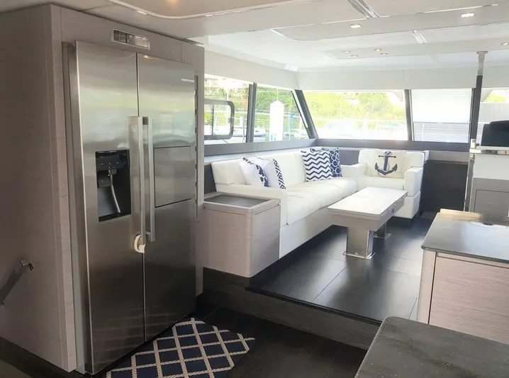 Calypso Yacht Photos Pics Luxurious interior of 2021 Fountaine Pajot MY6 yacht with modern kitchen and stylish seating area.