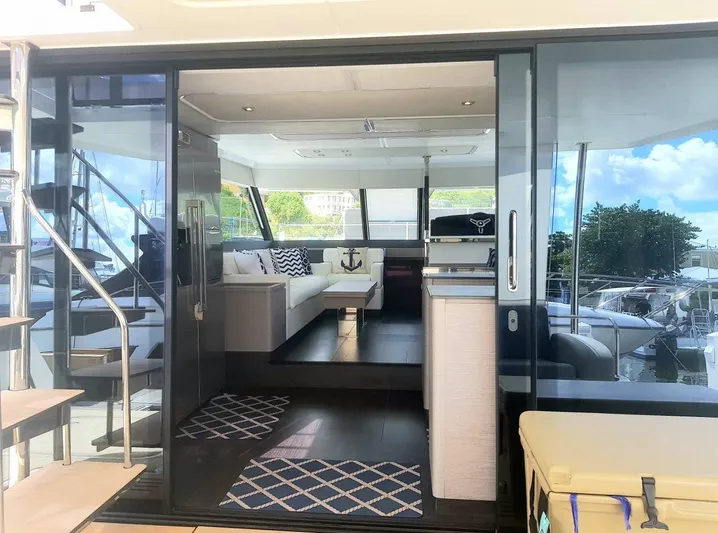 Calypso Yacht Photos Pics Luxurious interior of 2021 Fountaine Pajot MY6 yacht with modern furnishings and large windows.
