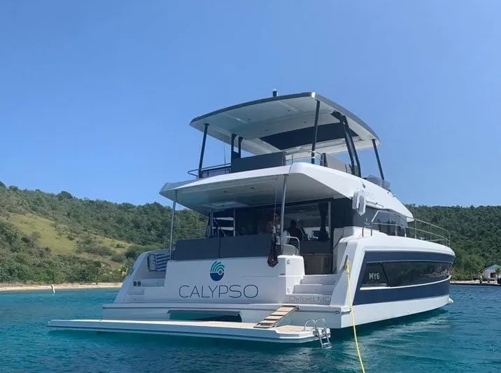Calypso Yacht Photos Pics 2021 Fountaine Pajot MY6 yacht "Calypso" anchored in clear blue water.