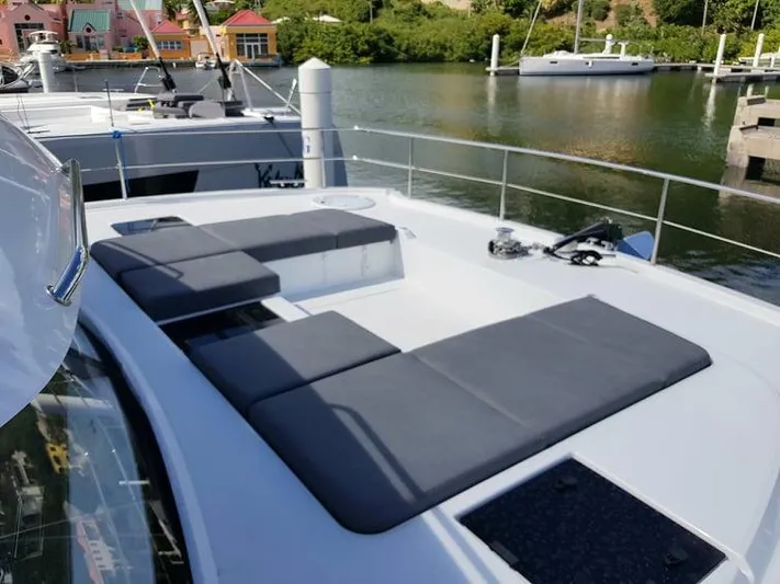 Calypso Yacht Photos Pics 2021 Fountaine Pajot MY6 yacht with spacious deck and seating area in marina.