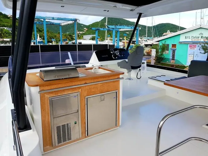 Calypso Yacht Photos Pics Flybridge of 2021 Fountaine Pajot MY6 yacht with outdoor kitchen and helm station.