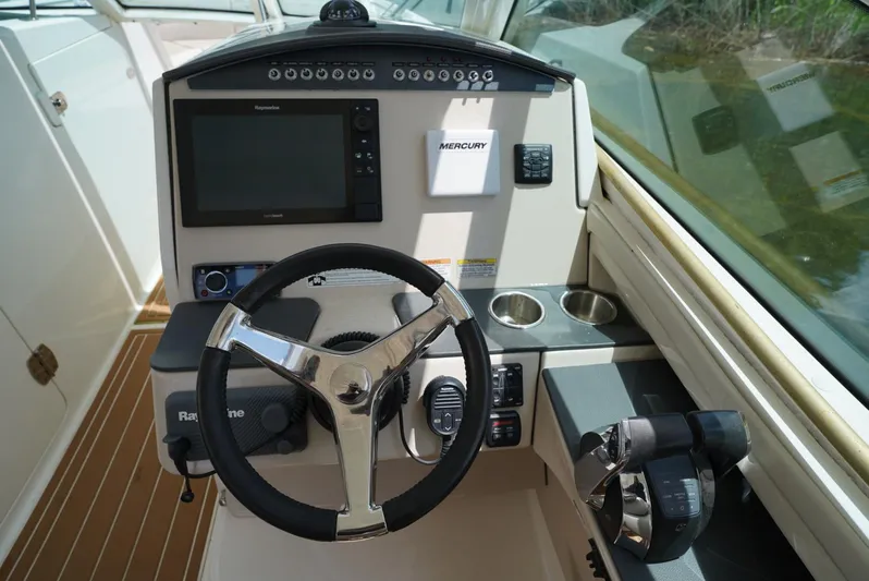  Yacht Photos Pics 2016 Boston Whaler 320 Vantage helm with steering wheel, navigation system, and controls.