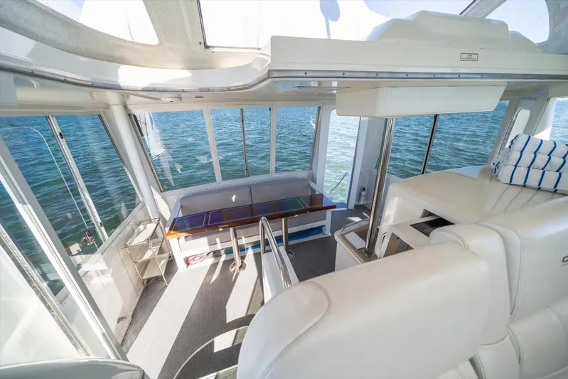 Cape San Blas Inn Yacht Photos Pics 1998 Carver 455 Aft Cabin Motor Yacht interior with ocean view, featuring seating and table.