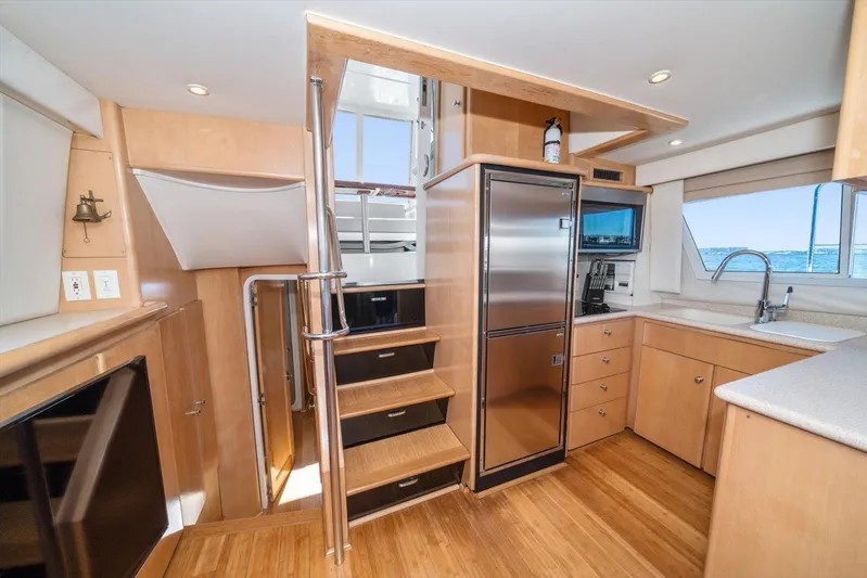 Cape San Blas Inn Yacht Photos Pics Interior of 1998 Carver 455 Aft Cabin Motor Yacht with modern kitchen and wooden flooring.