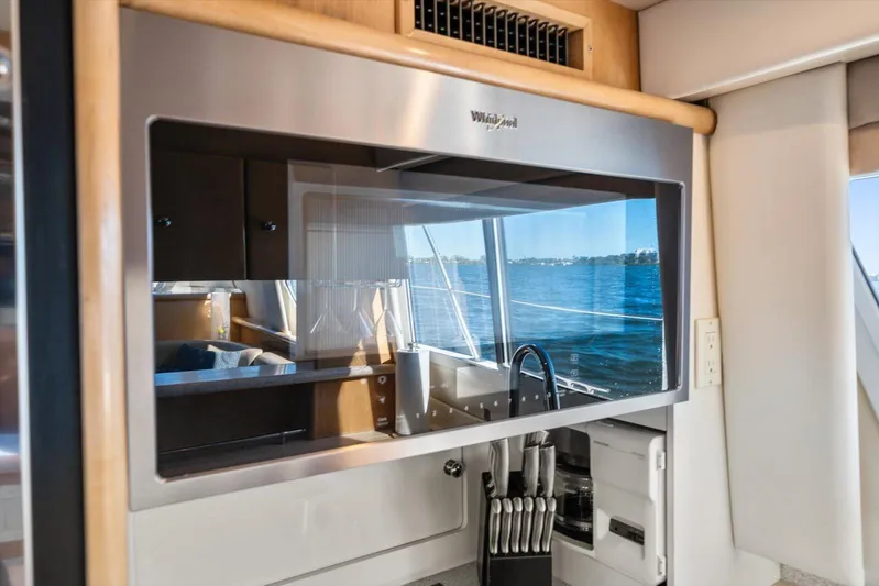 Cape San Blas Inn Yacht Photos Pics Interior of 1998 Carver 455 Aft Cabin Motor Yacht with kitchen view and water reflection.