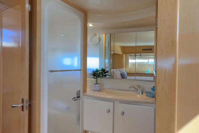 Cape San Blas Inn Yacht Photos Pics 1998 Carver 455 Aft Cabin Motor Yacht bathroom with shower, sink, and mirror.