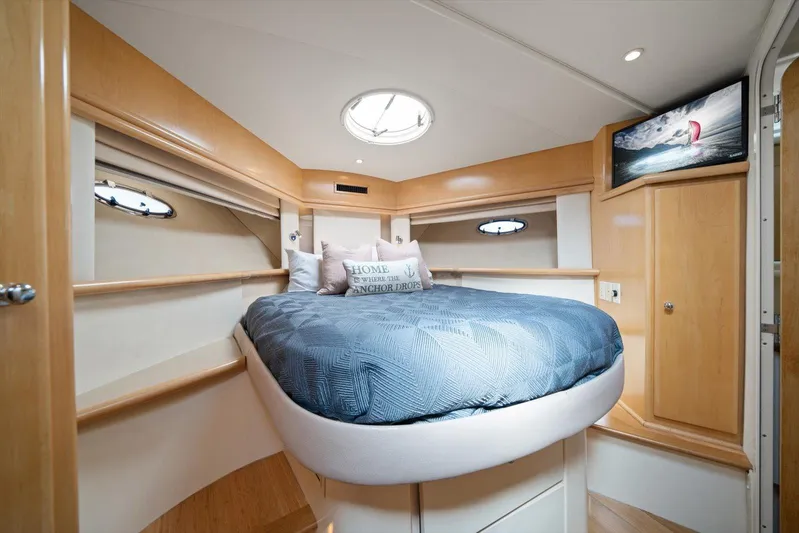 Cape San Blas Inn Yacht Photos Pics Luxurious bedroom in 1998 Carver 455 Aft Cabin Motor Yacht with cozy bedding and nautical decor.