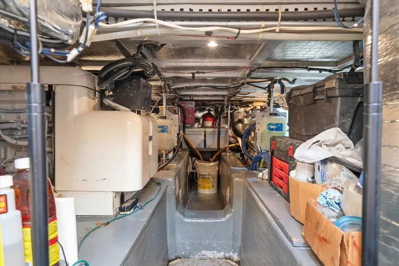 Cape San Blas Inn Yacht Photos Pics Engine room of 1998 Carver 455 Aft Cabin Motor Yacht, featuring equipment and storage.