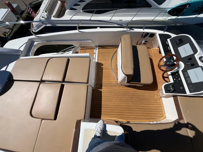  Yacht Photos Pics 2003 Sealine F425 yacht deck with tan seating and wooden flooring.