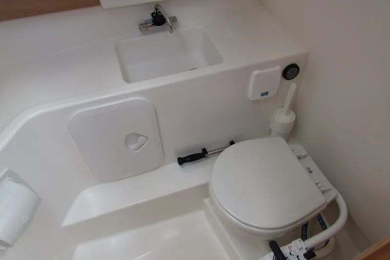 Yacht Photos Pics Compact bathroom in 2025 Nimbus Weekender 9 boat with toilet and sink.