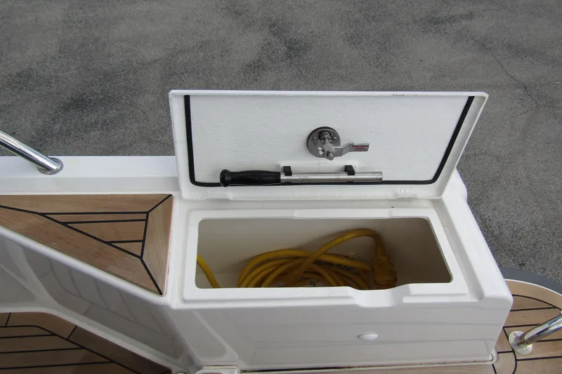 Yacht Photos Pics Storage compartment on 2025 Nimbus Weekender 9 boat, containing yellow cable.