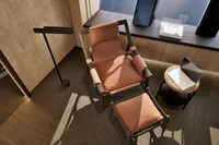 Luxurious seating area on 2026 custom motor yacht with modern chair and ottoman.