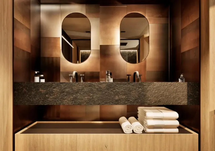 Project Ice Yacht Photos Pics Luxurious yacht bathroom with dual mirrors, modern sinks, and neatly stacked towels, 2026 model.