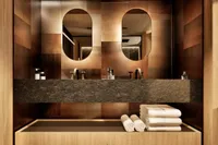 Luxurious yacht bathroom with dual mirrors, modern sinks, and neatly stacked towels, 2026 model.