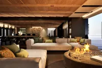 Luxurious interior of 2026 custom motor yacht with cozy seating and modern fireplace.