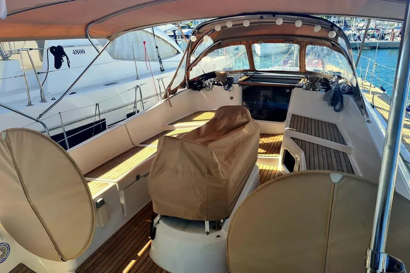 Yacht Photos Pics 2009 Jeanneau Sun Odyssey 50 DS cockpit with covered seating and wooden deck.