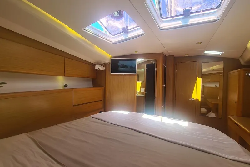  Yacht Photos Pics Luxurious interior of 2009 Jeanneau Sun Odyssey 50 DS yacht with skylights and wood finish.