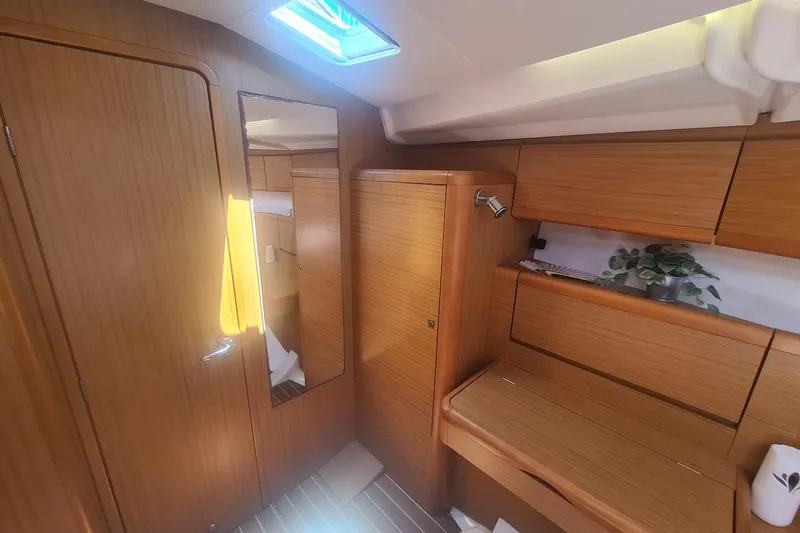 Yacht Photos Pics 2009 Jeanneau Sun Odyssey 50 DS interior with wooden cabinetry and natural light.