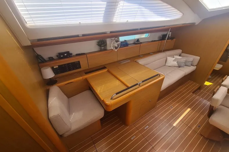  Yacht Photos Pics Interior of 2009 Jeanneau Sun Odyssey 50 DS yacht with elegant wood finish and cozy seating.
