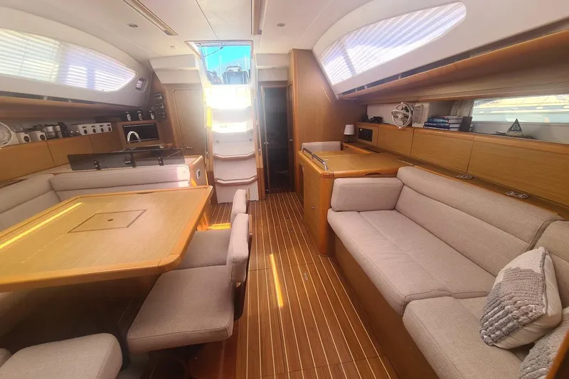  Yacht Photos Pics Luxurious interior of 2009 Jeanneau Sun Odyssey 50 DS yacht with elegant wood finish.