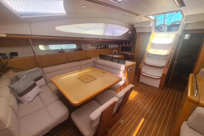  Yacht Photos Pics Luxurious interior of 2009 Jeanneau Sun Odyssey 50 DS sailboat with elegant wood finish.