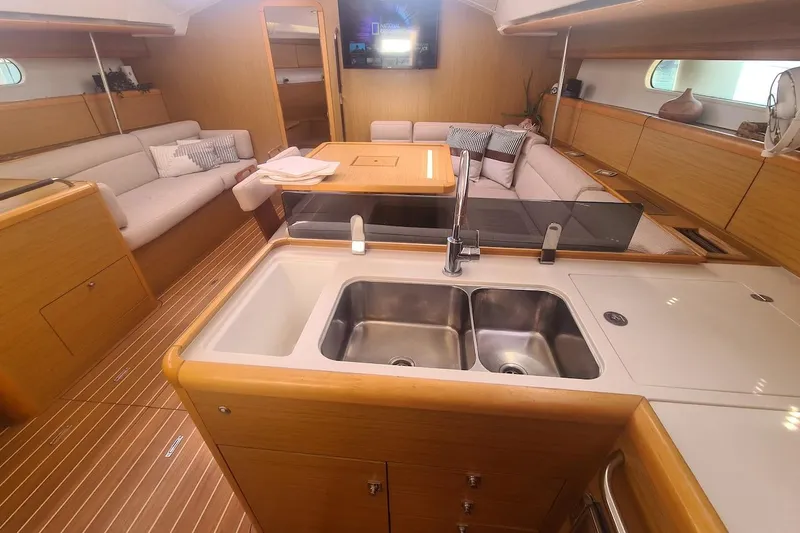  Yacht Photos Pics Luxurious interior of 2009 Jeanneau Sun Odyssey 50 DS yacht with modern kitchen and seating area.