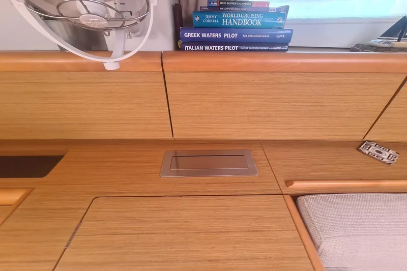  Yacht Photos Pics Interior of 2009 Jeanneau Sun Odyssey 50 DS with books and fan.