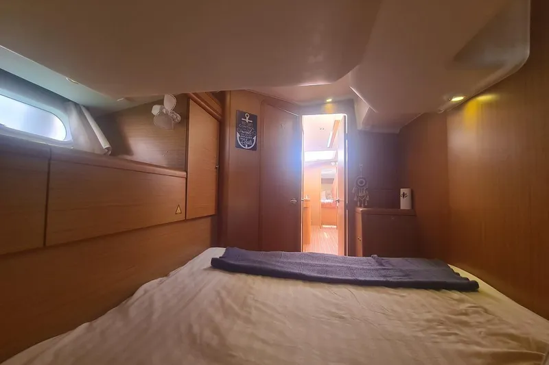  Yacht Photos Pics Cozy cabin interior of 2009 Jeanneau Sun Odyssey 50 DS sailboat, featuring wooden finishes.