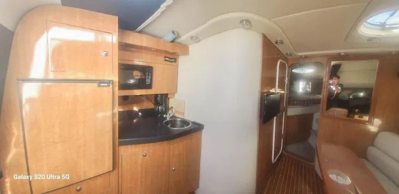 Ab2967908 Yacht Photos Pics 2004 Regal Commodore 3560 yacht interior with kitchenette and seating area.