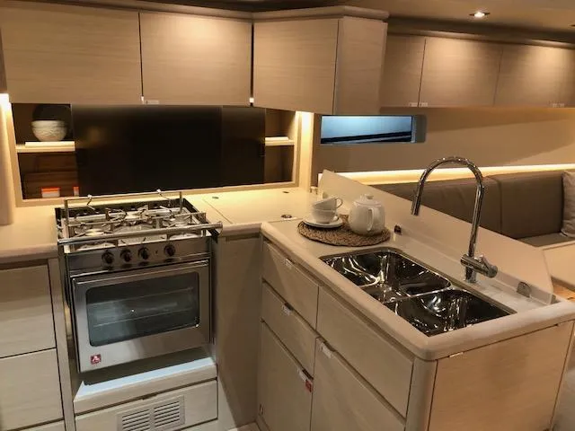 Sultans Of Swing Yacht Photos Pics Modern kitchen interior of 2020 Solaris 50 yacht with stove, sink, and cabinetry.