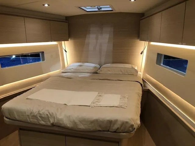Sultans Of Swing Yacht Photos Pics Luxurious cabin interior of 2020 Solaris 50 yacht with cozy bed and ambient lighting.